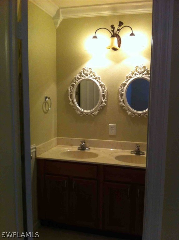 17 Iowa Road Lehigh Acres, FL 33936 - Photo 12 of 18 a bathroom with a granite countertop sink and a mirror