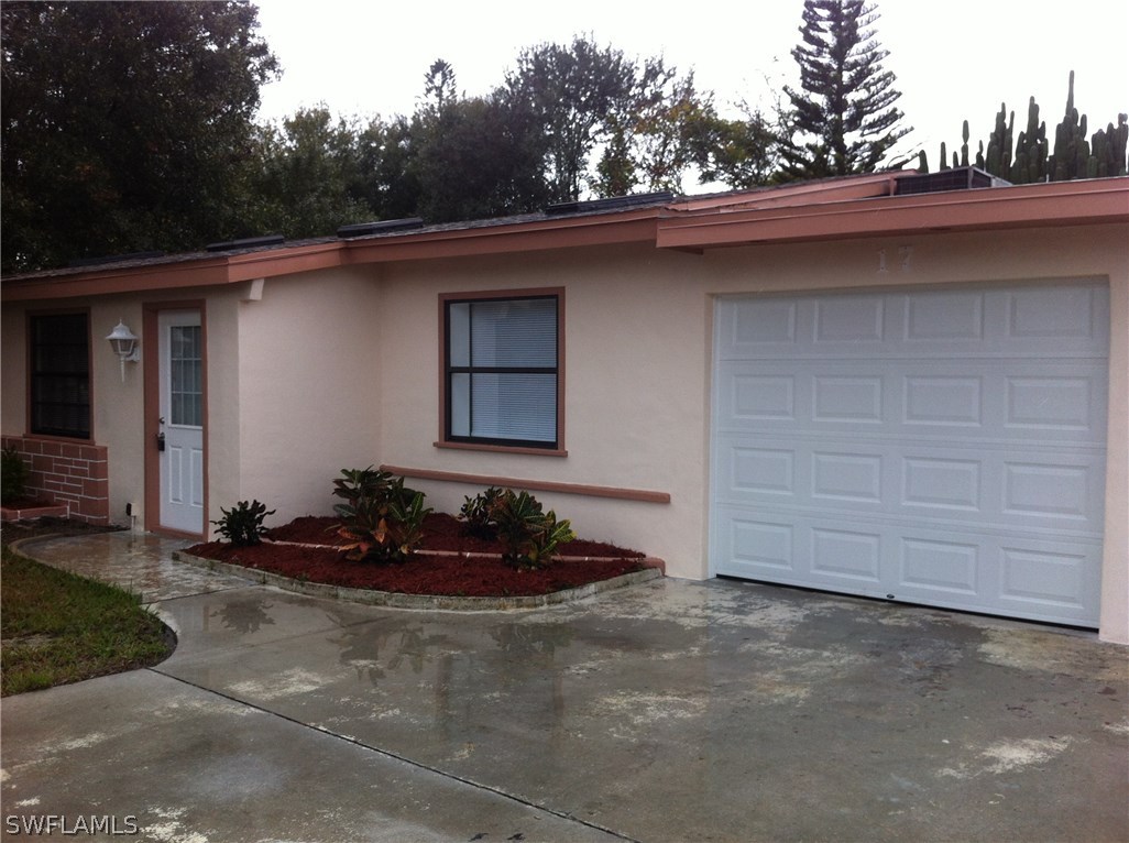 17 Iowa Road Lehigh Acres, FL 33936 - Photo 3 of 18 a front view of a house