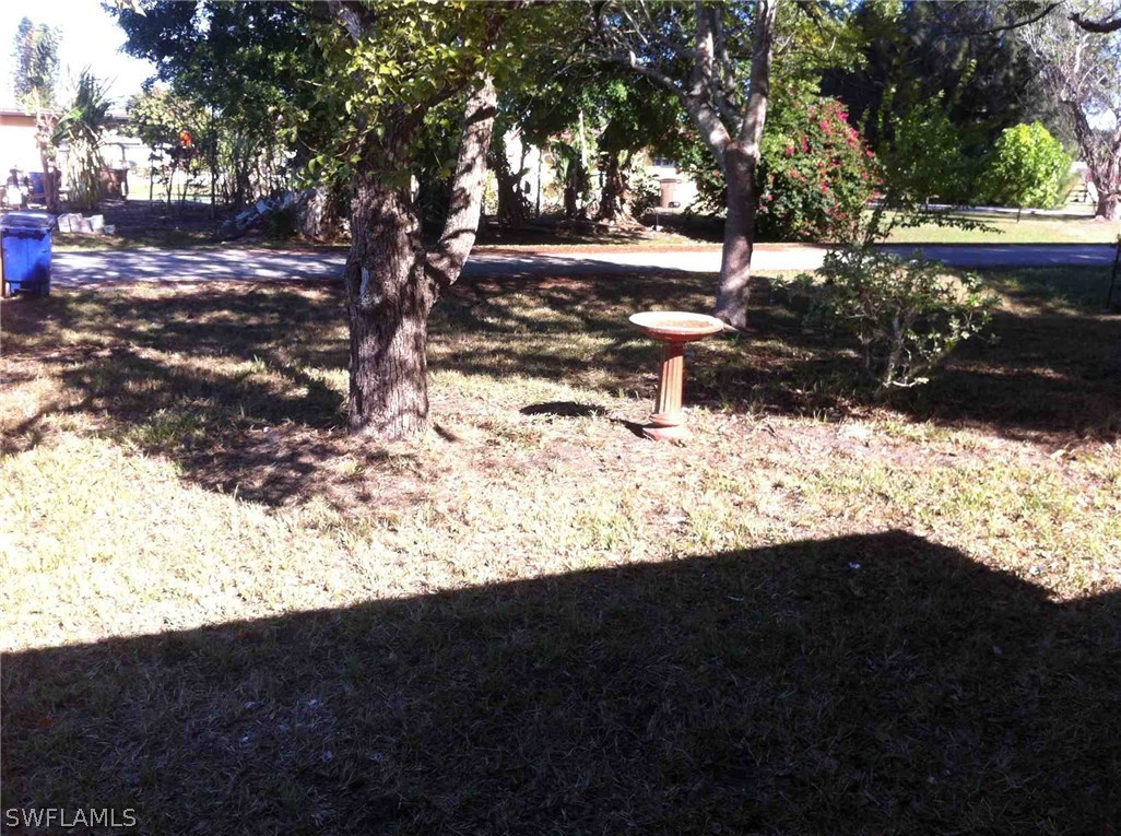 17 Iowa Road Lehigh Acres, FL 33936 - Photo 4 of 18 a view of outdoor space with green space