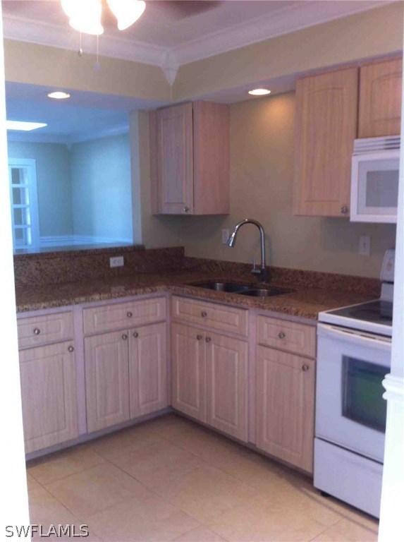 17 Iowa Road Lehigh Acres, FL 33936 - Photo 9 of 18 a kitchen with granite countertop a cabinets and white stove