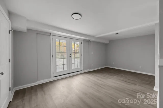 a view of empty room with wooden walls