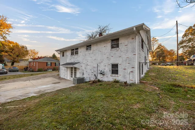 a big house with a big yard and more potted plants