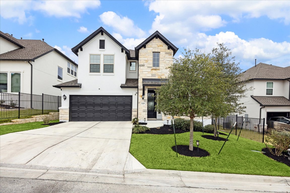 1220 Brasano Place Leander, TX 78641 - Photo 1 of 1 a front view of a house with a yard and potted plants