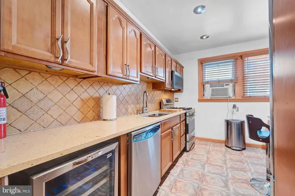 a view of a kitchen area with furniture window and wooden floor