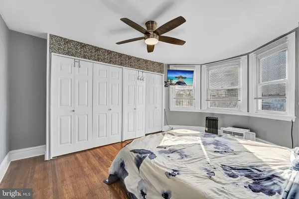 a bedroom with a bed and a ceiling fan