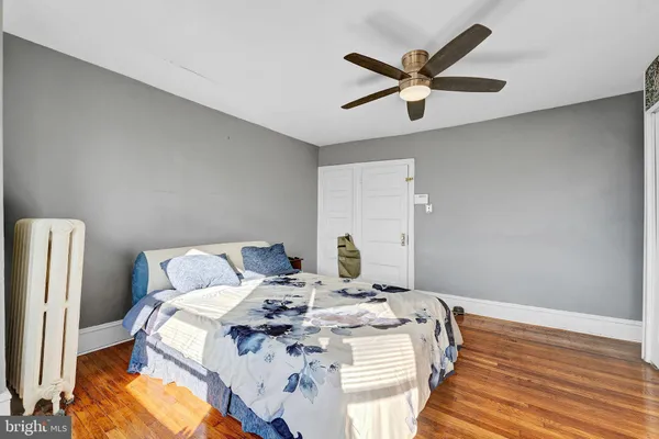 a bedroom with a bed next to a window with a chandelier