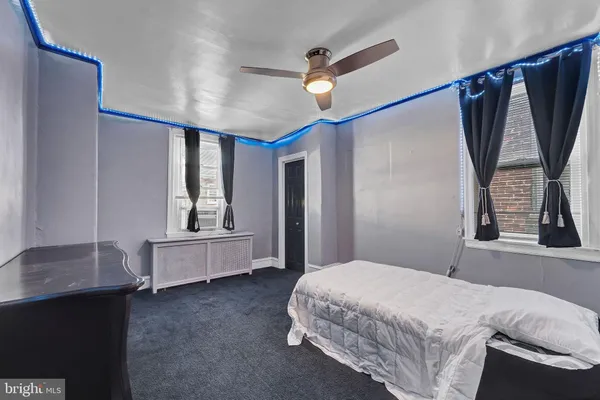 a bedroom with a bed and a ceiling fan