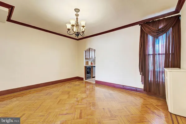 a view of an empty room with a fireplace and a window