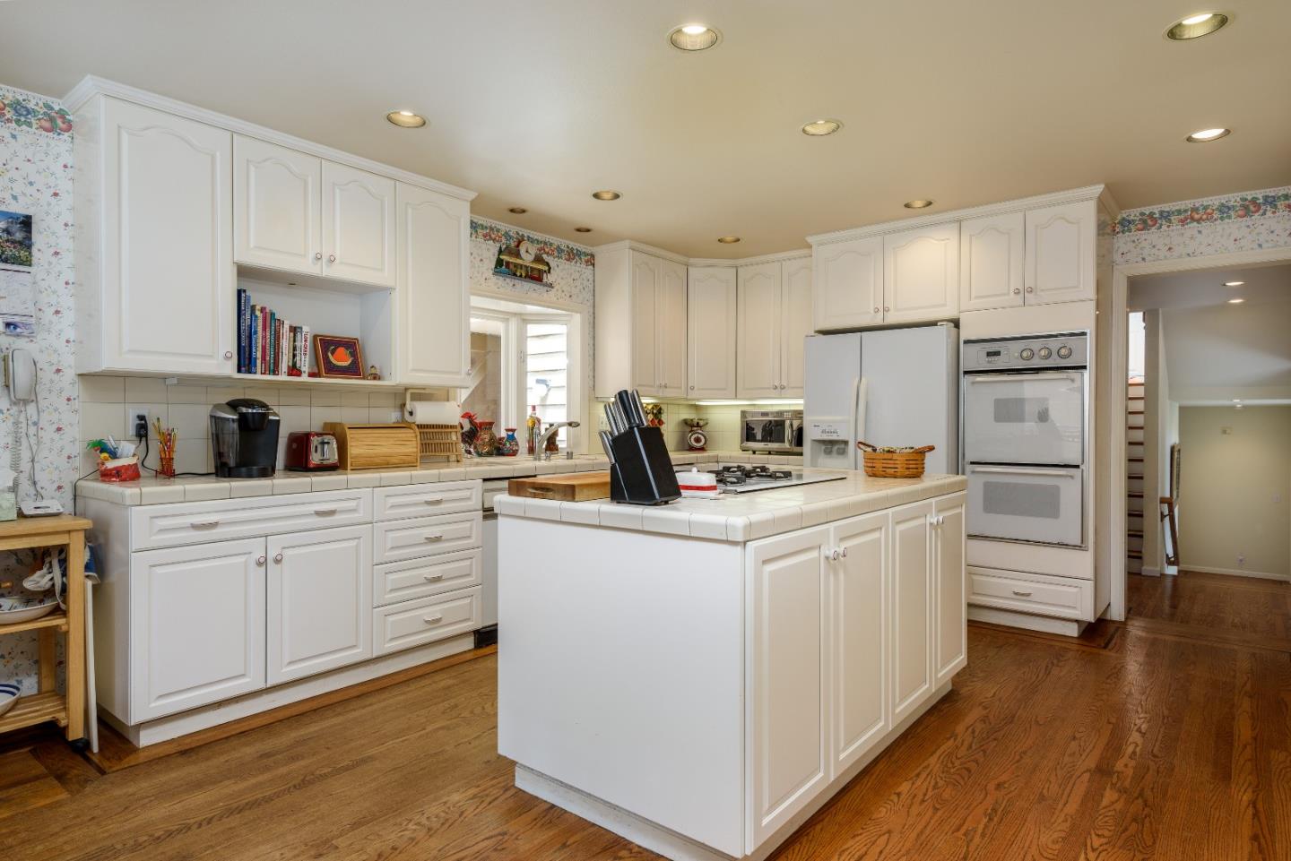 364 Genevieve Avenue Pacifica, CA 94044 - Photo 7 of 24 a kitchen with white cabinets and stainless steel appliances