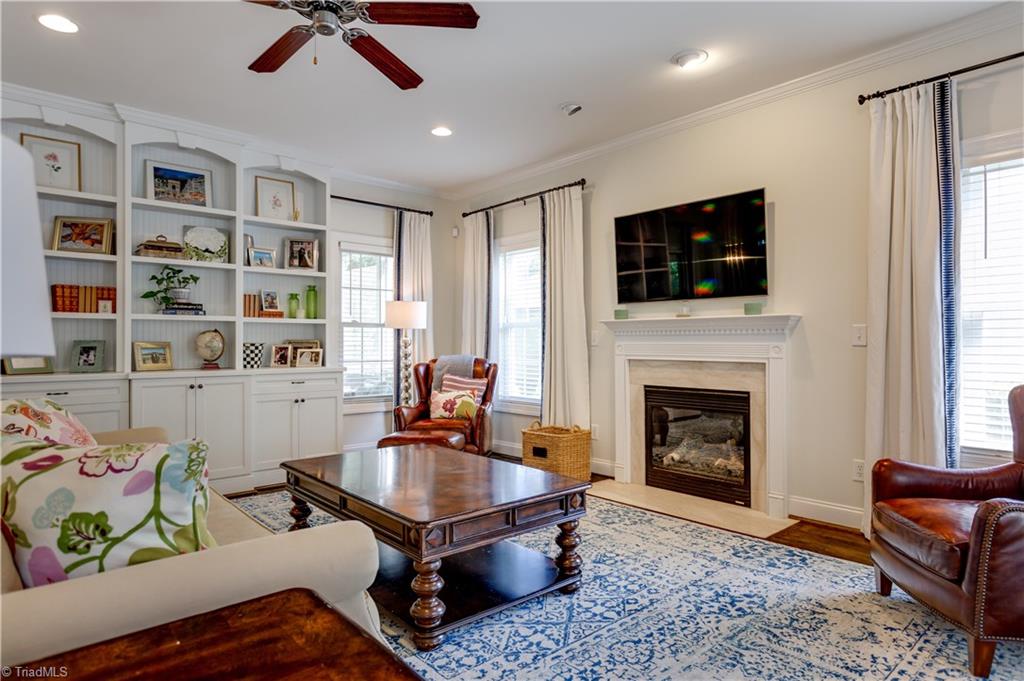 4506 Charlottesville Road Greensboro, NC 27410 - Photo 7 of 30 Handsome floor to ceiling built ins with bead board backing and gas fireplace w/ recessed lighting up above.