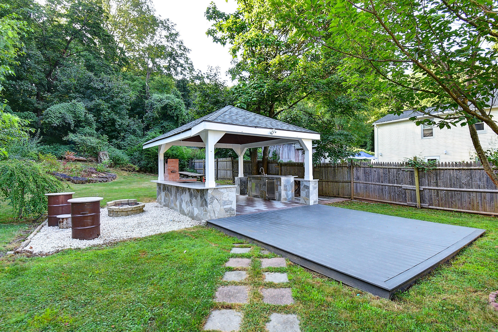 631 High Street Naugatuck, CT 06770 - Photo 7 of 36 a view of a chair and table under an umbrella in the yard