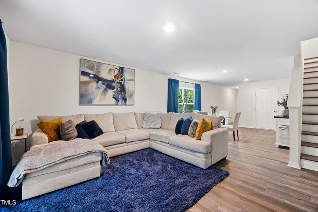 a living room with furniture or couch and a wooden floor