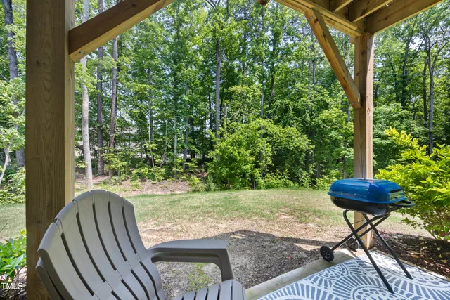 a view of a porch with furniture and a yard