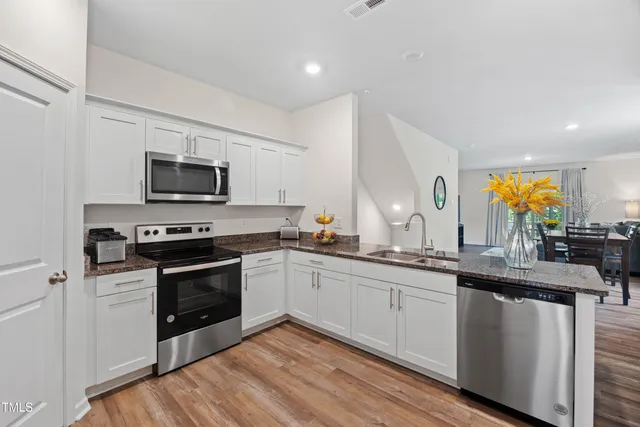 a kitchen with sink stove and microwave