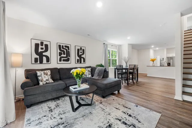 a living room with furniture and paintings on the wall