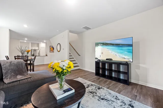 a living room with furniture flowerpot and wooden floor