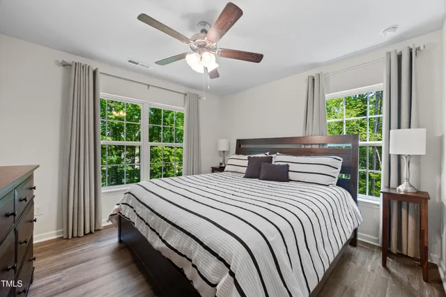 a bedroom with a large bed and a large window