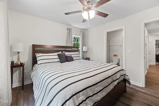 a bedroom with bed and a chandelier