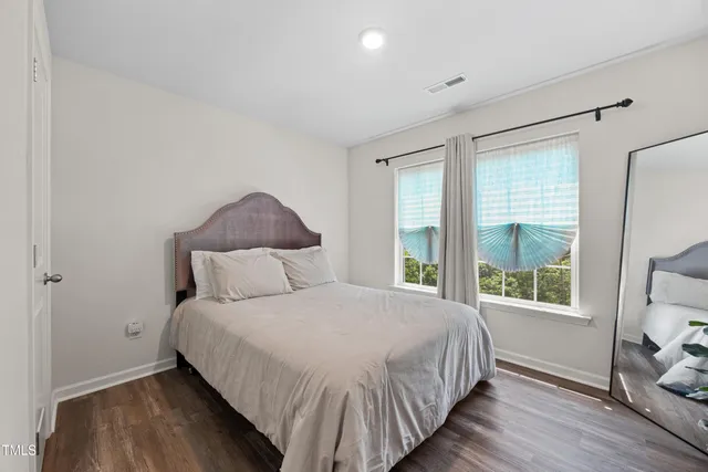 a bedroom with a large bed and a window