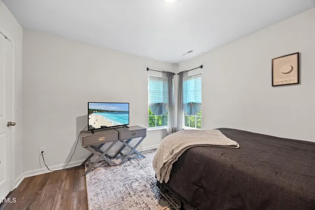 a bed sitting in a bedroom next to a window