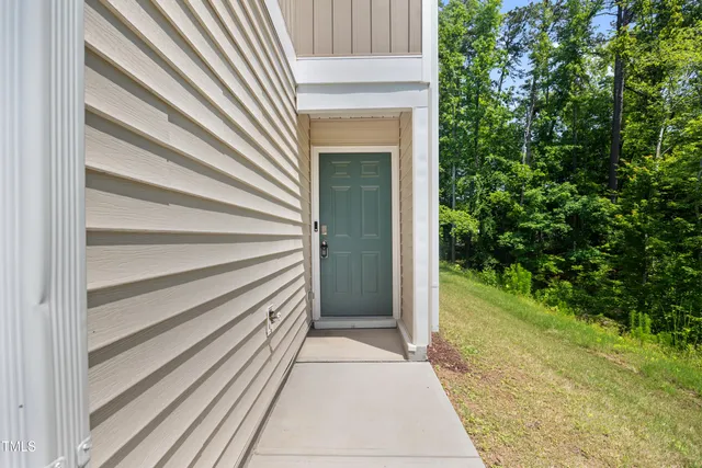 a view of a house with a door and a yard