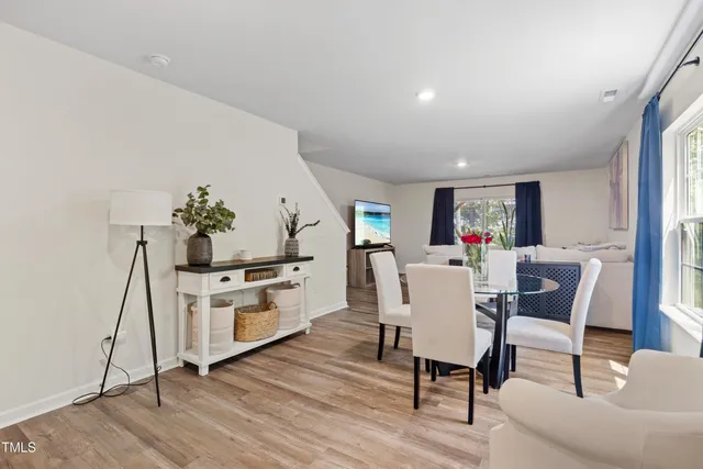 a dining room with furniture and wooden floor