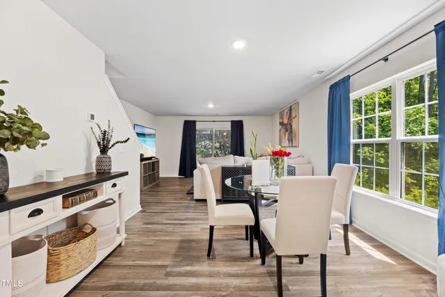 a dining room with furniture entryway and wooden floor