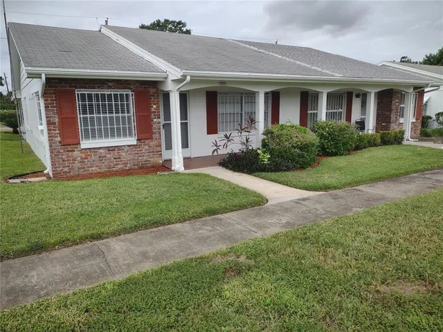 a front view of a house with a yard and porch
