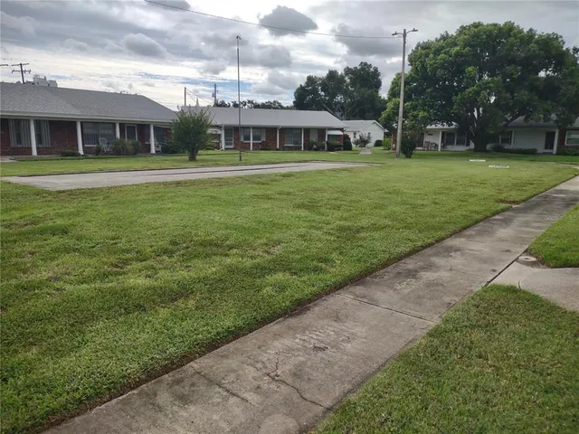 a front view of a house with a yard table and chairs