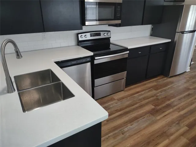 a kitchen with a stove and a refrigerator