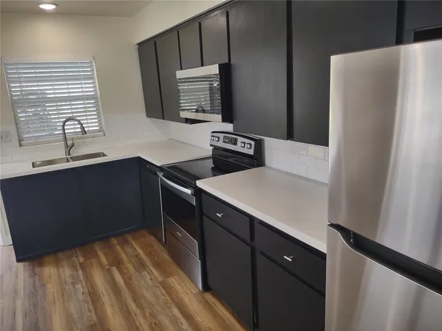 a kitchen with a sink appliances and cabinets