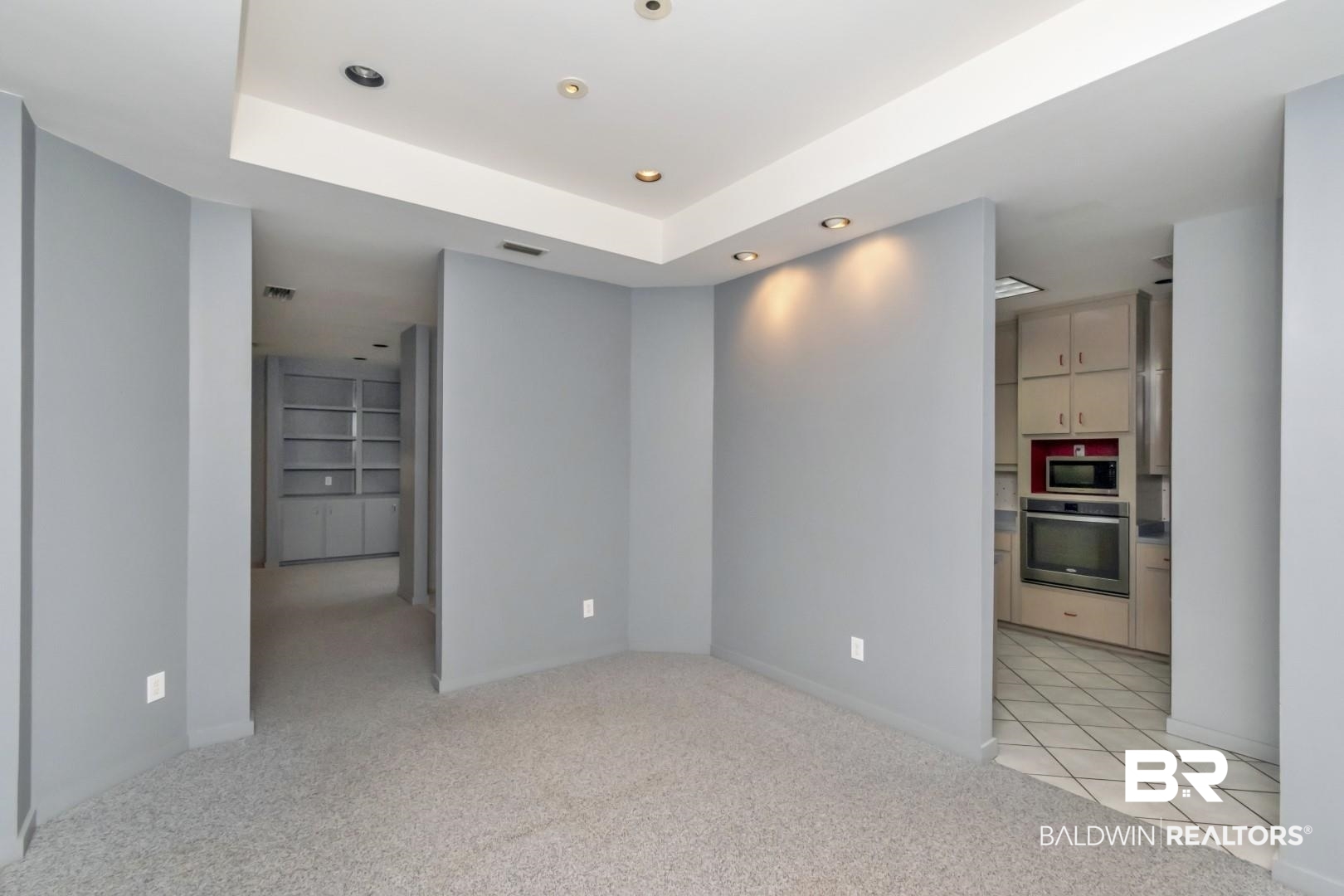 1205 Hillcrest Crossing East Mobile, AL 36695 - Photo 10 of 40 Empty room with a raised ceiling and light colored carpet