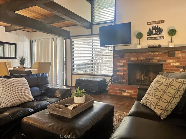 a view of a room with furniture and large windows