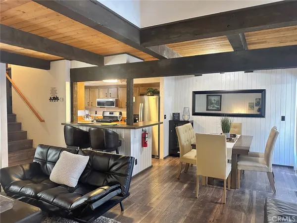 a view of a living room with furniture and wooden floor