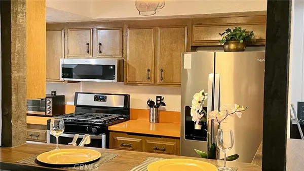 a kitchen with stainless steel appliances granite countertop a refrigerator and a stove