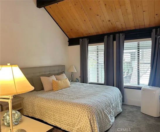 a bedroom with a bed couch and window