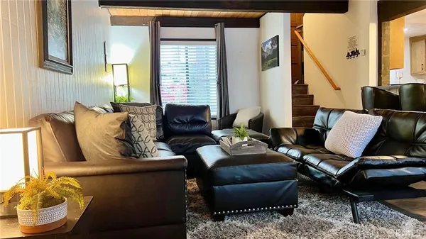 a living room with furniture stove and a fireplace