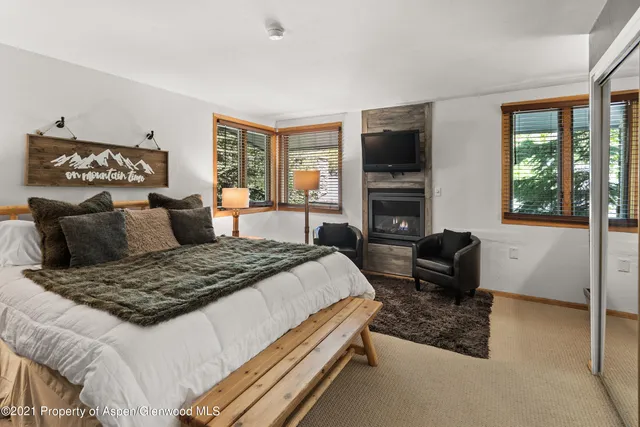 a bedroom with a bed and glass windows