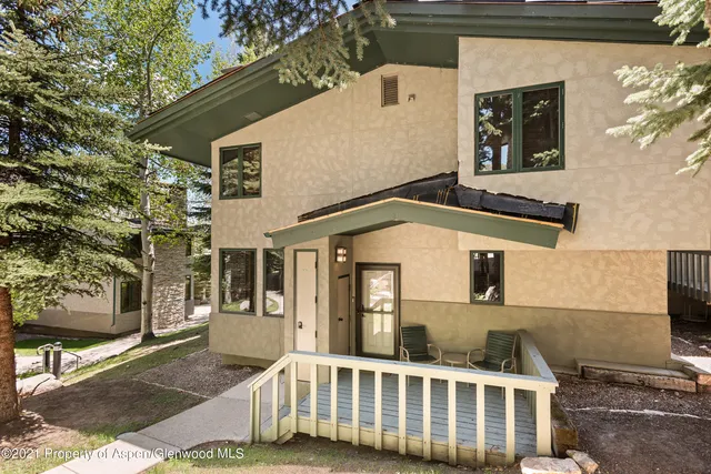 a front view of a house with large windows