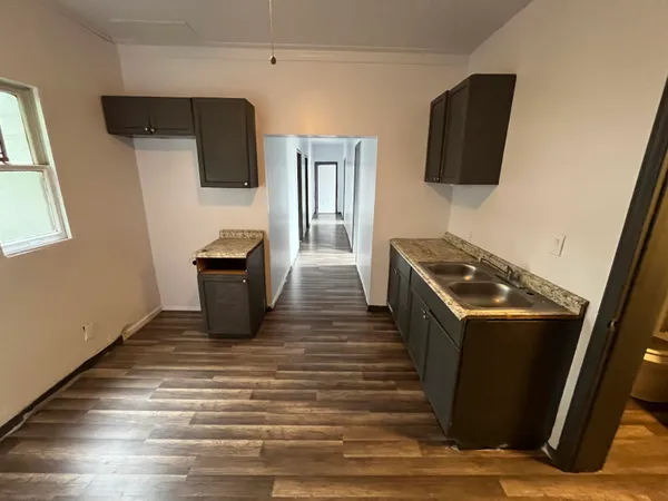 a kitchen with stainless steel appliances a refrigerator a stove top oven a sink and dishwasher