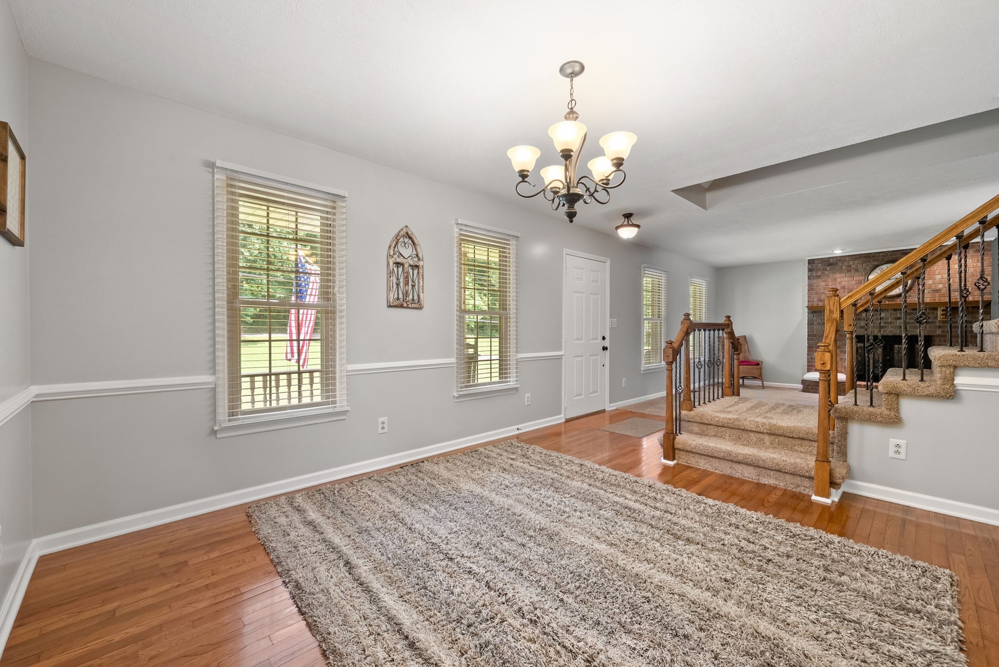 915 Rocky Hollow Road Erin, TN 37061 - Photo 13 of 49 a view of a livingroom with a furniture wooden floor and a chandelier