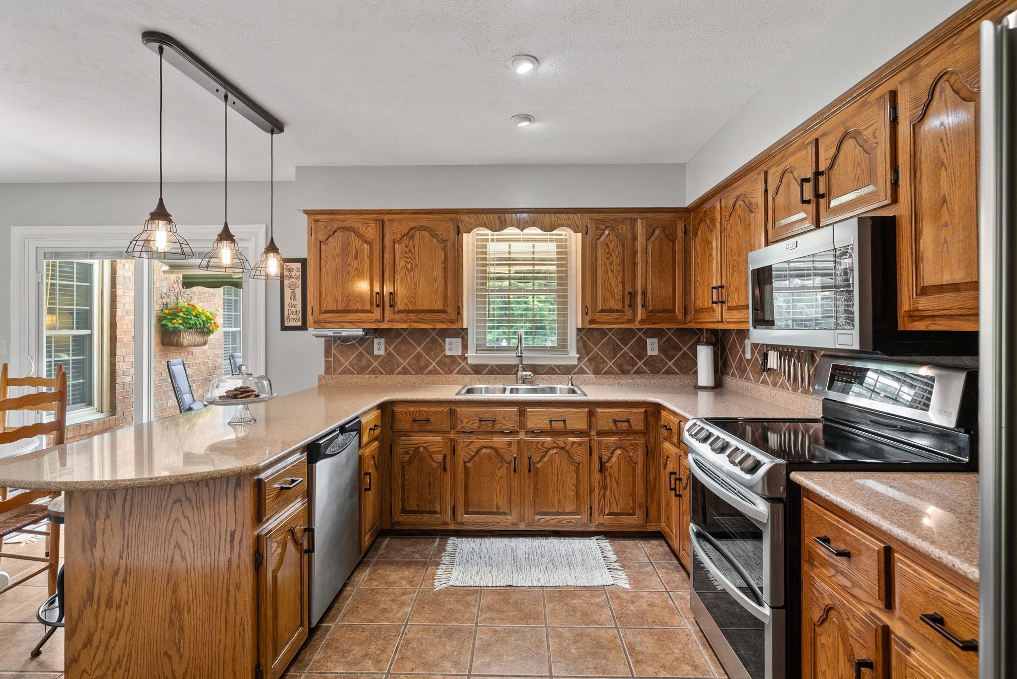 915 Rocky Hollow Road Erin, TN 37061 - Photo 14 of 49 a kitchen with kitchen island granite countertop a sink stove and cabinets