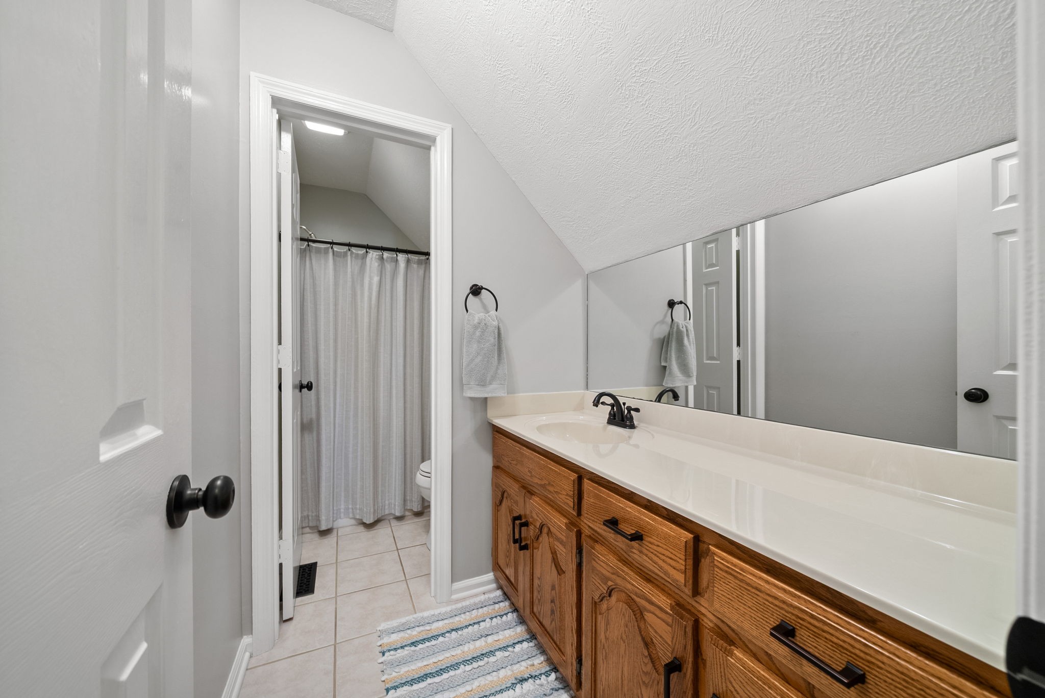 915 Rocky Hollow Road Erin, TN 37061 - Photo 24 of 49 a spacious bathroom with a double vanity sink and mirror