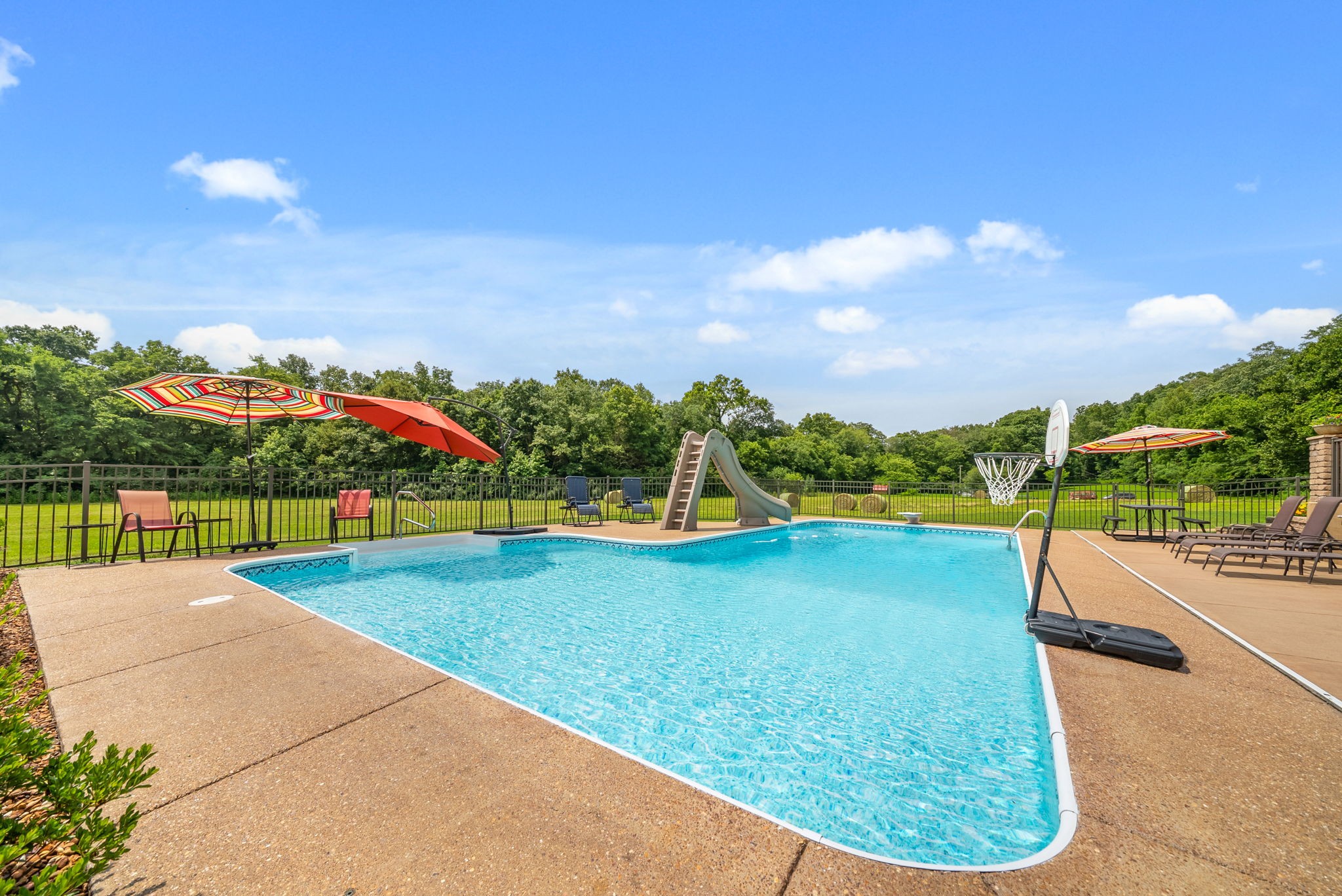915 Rocky Hollow Road Erin, TN 37061 - Photo 34 of 49 a view of a swimming pool with an outdoor seating and a garden