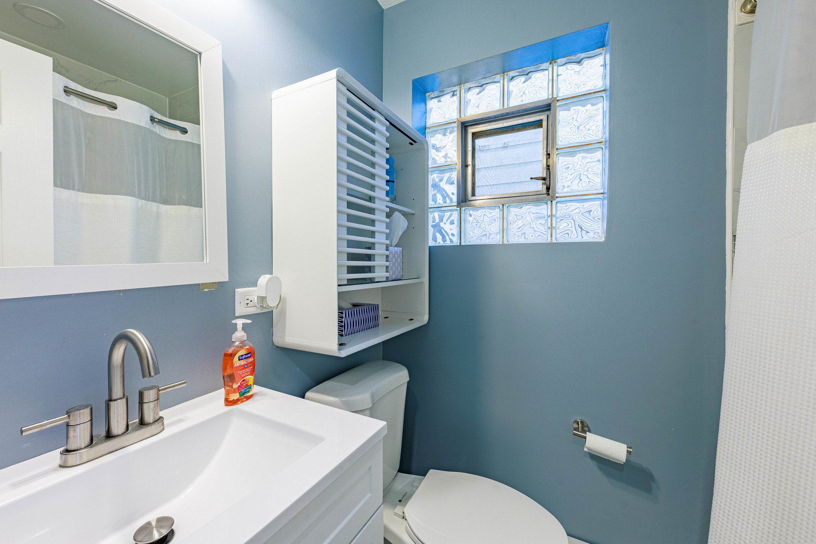 3702 West George Street Chicago, IL 60618 - Photo 12 of 20 a bathroom with a sink a toilet and a window