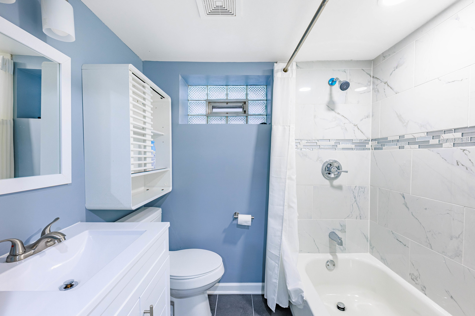 3702 West George Street Chicago, IL 60618 - Photo 16 of 20 a bathroom with a sink a toilet and shower