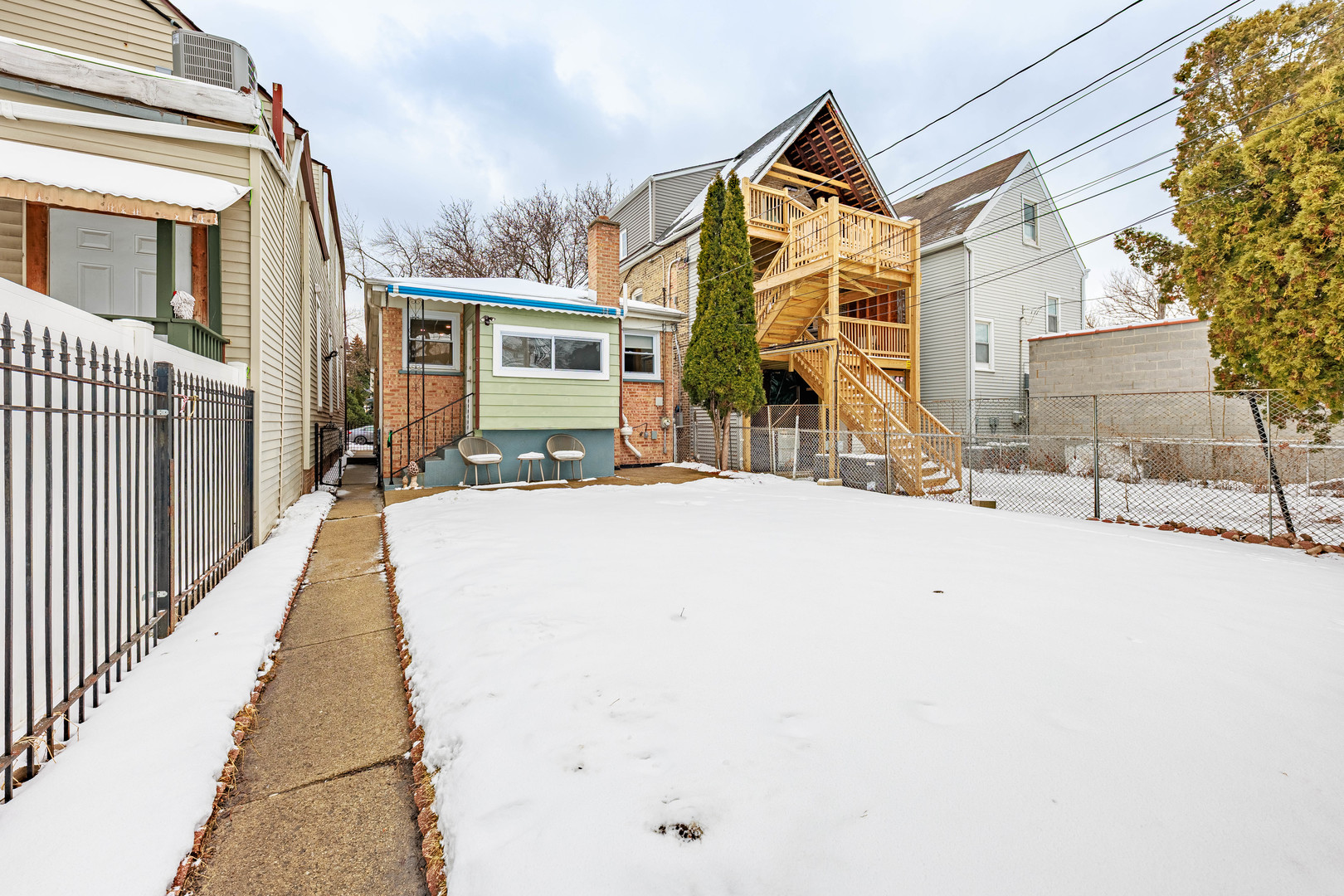 3702 West George Street Chicago, IL 60618 - Photo 19 of 20 a view of a house with a snow on the wall