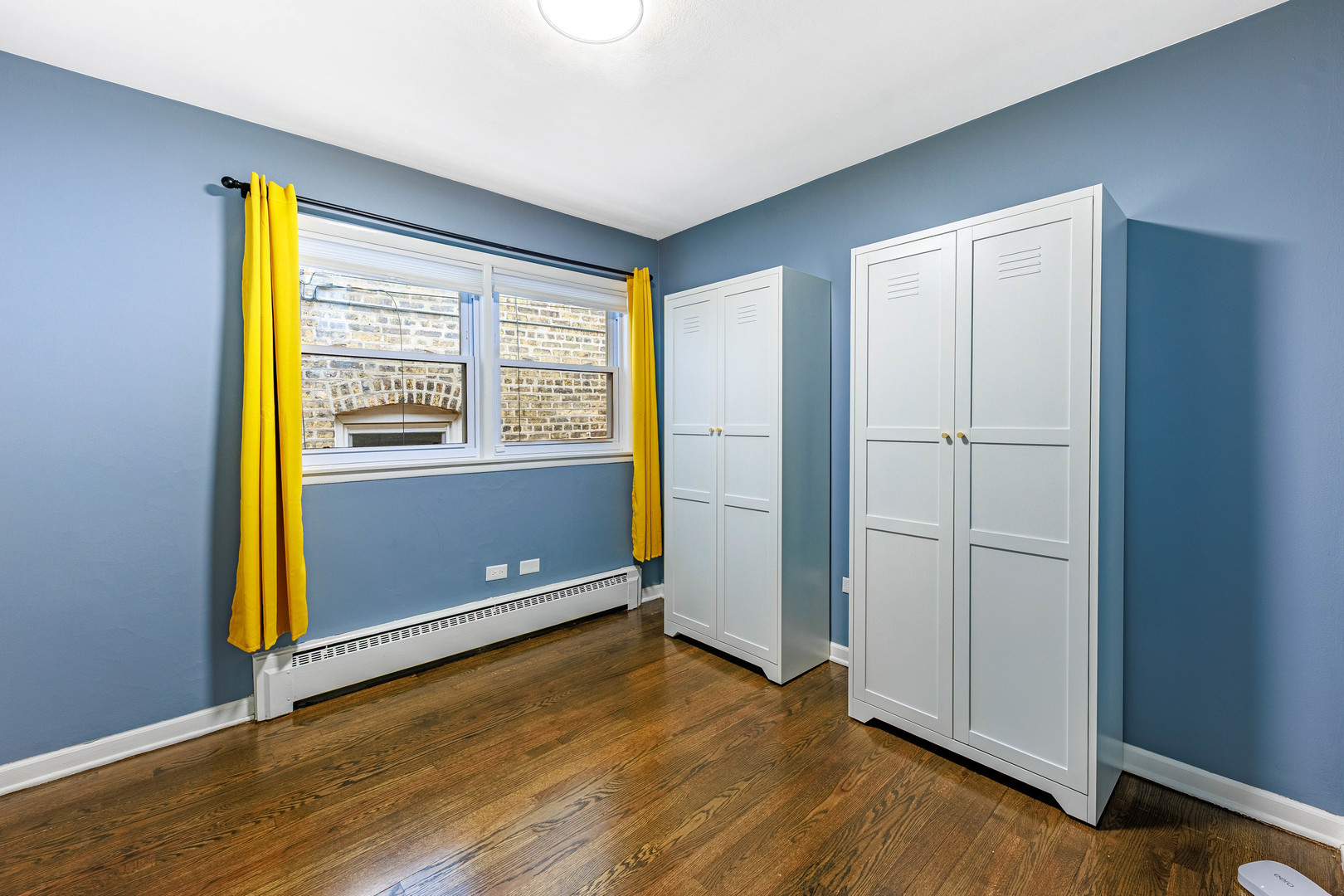 3702 West George Street Chicago, IL 60618 - Photo 10 of 20 an empty room with wooden floor and windows