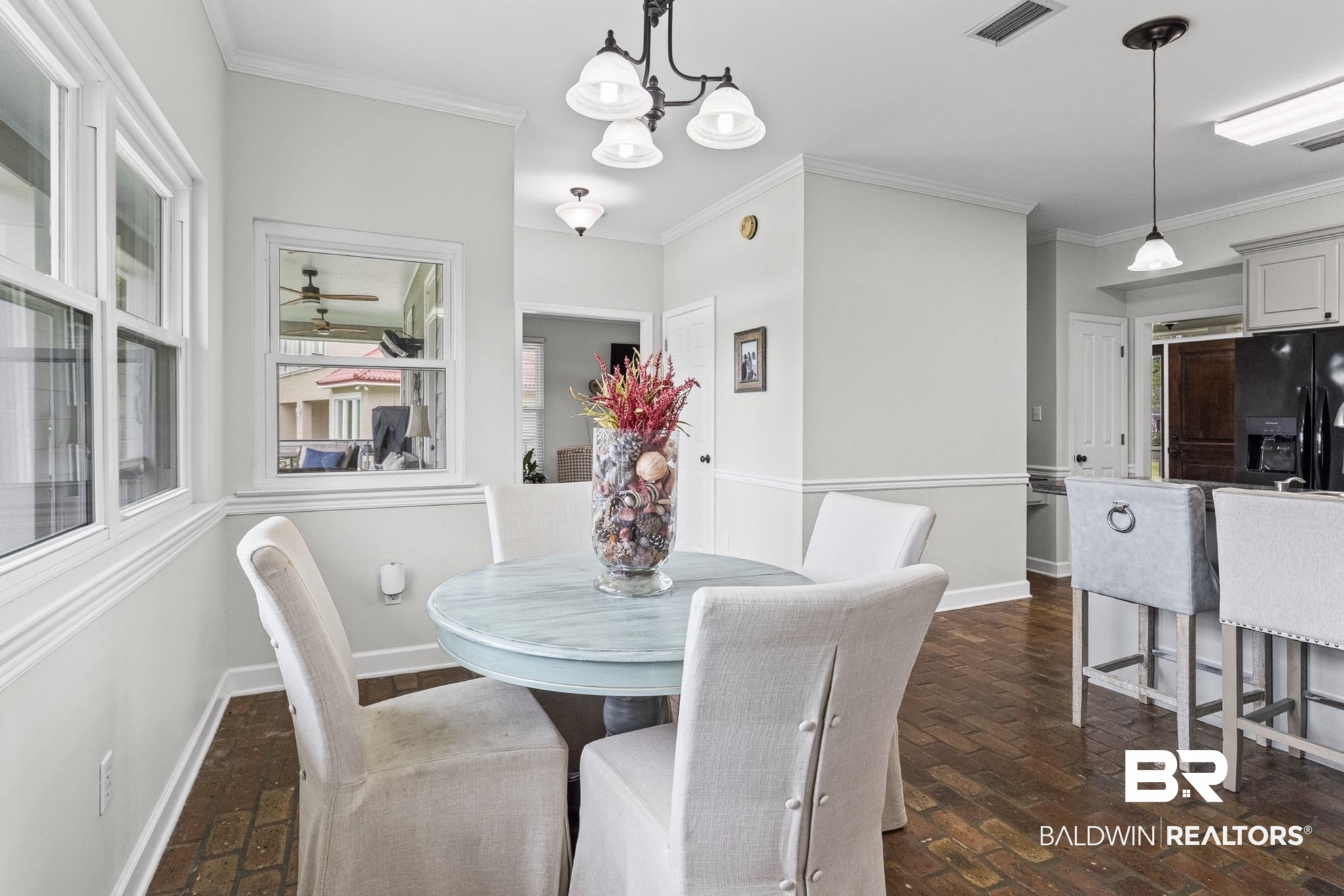 12171 Marguerite Drive Coden, AL 36523 - Photo 11 of 44 Dining area featuring brick-finish flooring and crown molding