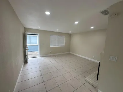 a kitchen with stainless steel appliances granite countertop a refrigerator and a stove